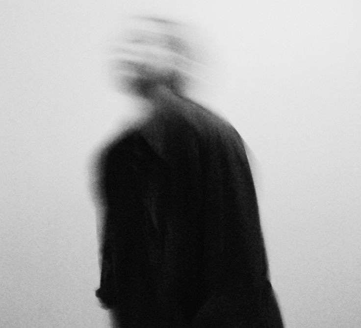 A figure in motion, blurred, against a pale background